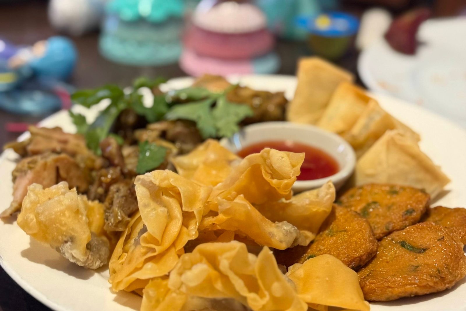 A platter of fried wontons, fish cakes and grilled pork